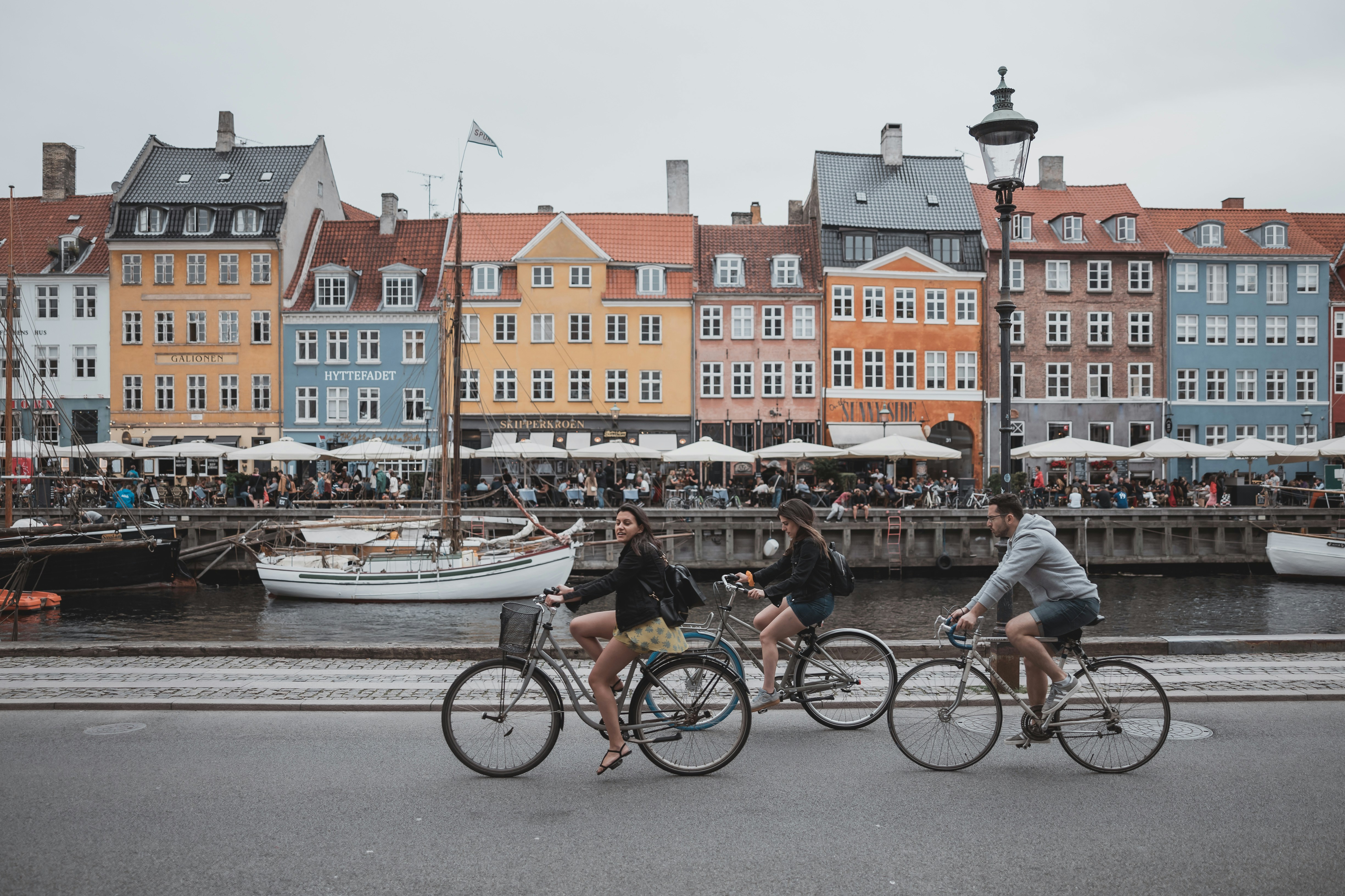 Colorful buildings along Nyhavn canal in Copenhagen with boats and warm sunlight